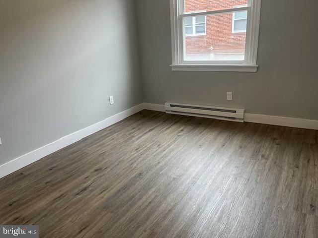6339 Morton Street Philadelphia, PA 19144 - Photo 6 of 13 an empty room with wooden floor and windows
