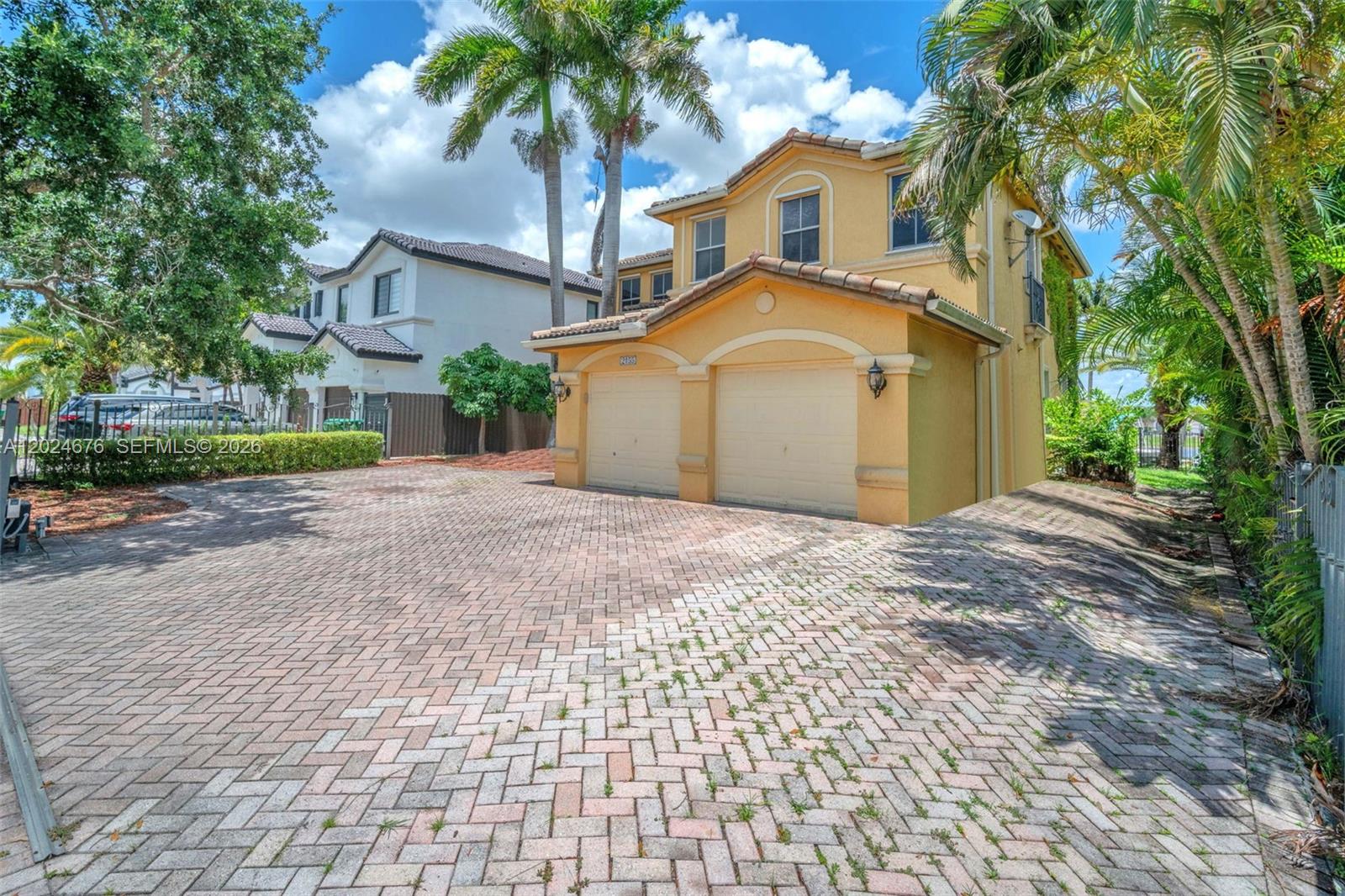 2155 Southwest 156th Court Miami, FL 33185 - Photo 3 of 57 a front view of a house with a yard and garage