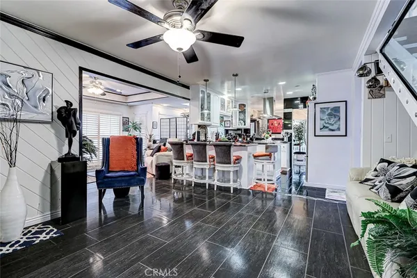 a living room with lots of furniture and kitchen view