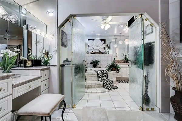 a kitchen with a sink a refrigerator and cabinets