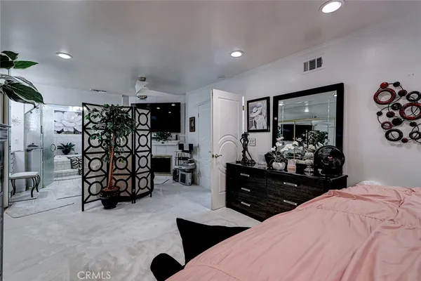 a bed room with a bed window and a mirror