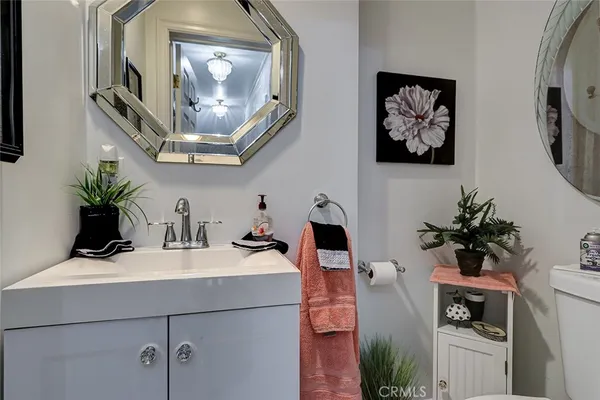 a bathroom with a sink a mirror and vanity