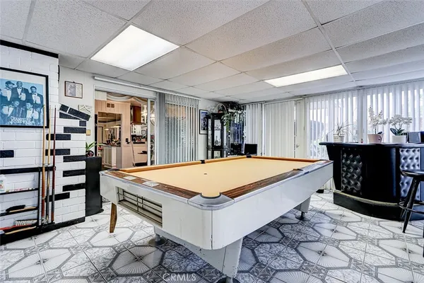 a room with pool table and window