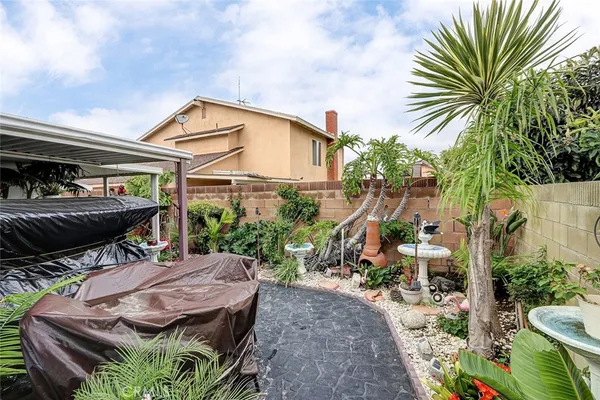 a view of backyard with outdoor seating and plants