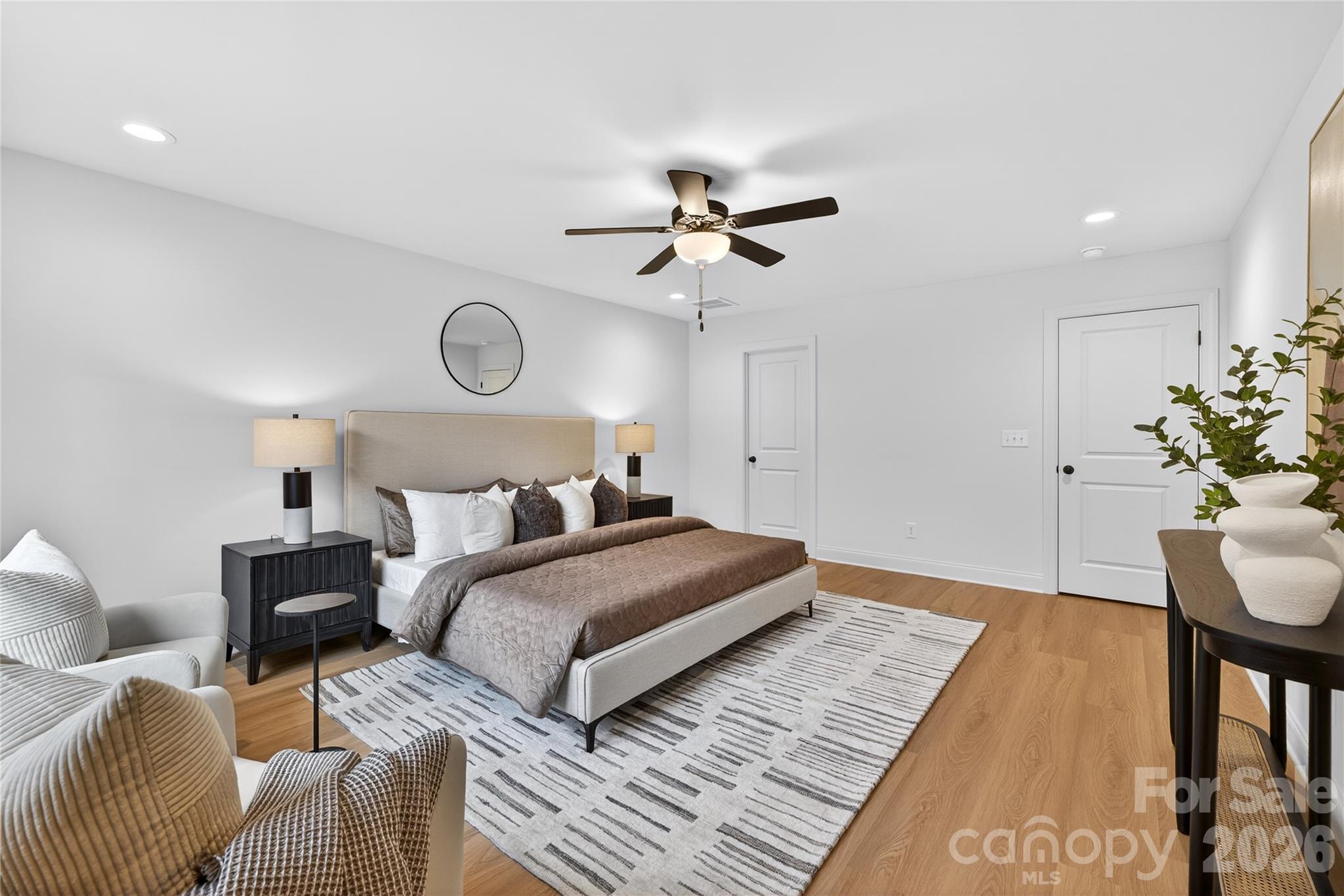 13103 Blacksmith Court Matthews, NC 28105 - Photo 24 of 32 a bedroom with bed and a chandelier