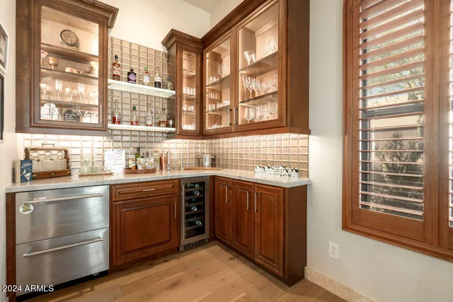 a living room with furniture a ceiling fan and a window