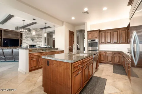 a kitchen with stainless steel appliances granite countertop a stove and a sink