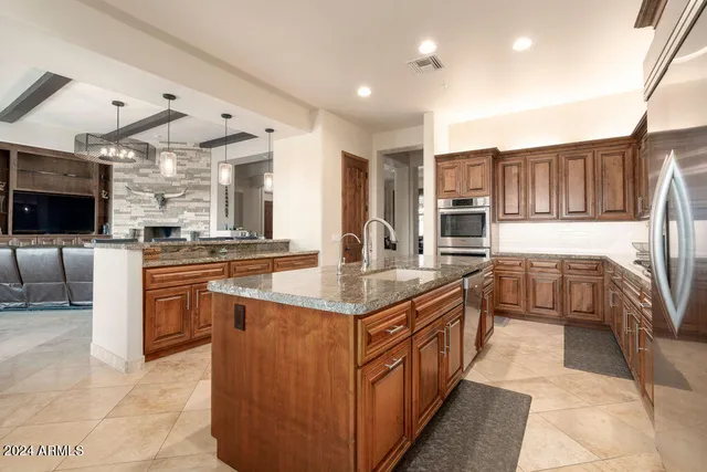 a kitchen with stainless steel appliances granite countertop a stove and a sink