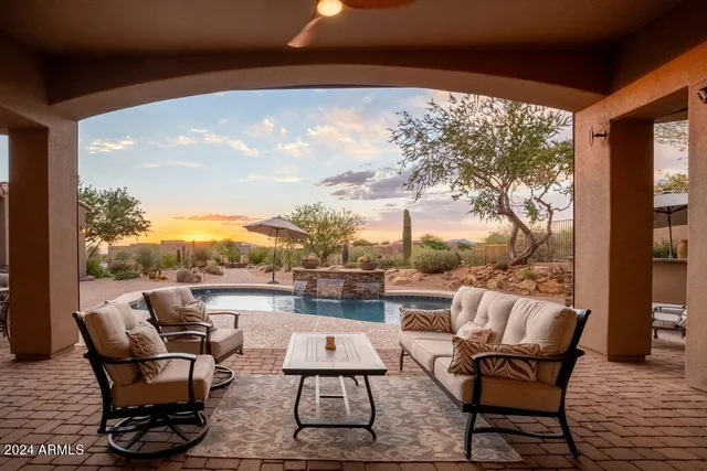 a spacious bedroom with a bed a couch and a flat tv screen