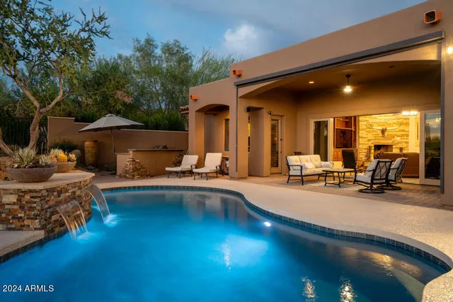 a swimming pool with outdoor seating and yard