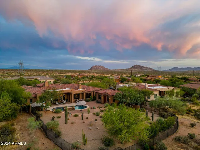 a spacious bedroom with a bed and a chandelier