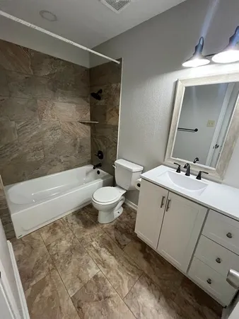 a bathroom with a sink mirror toilet and bathtub