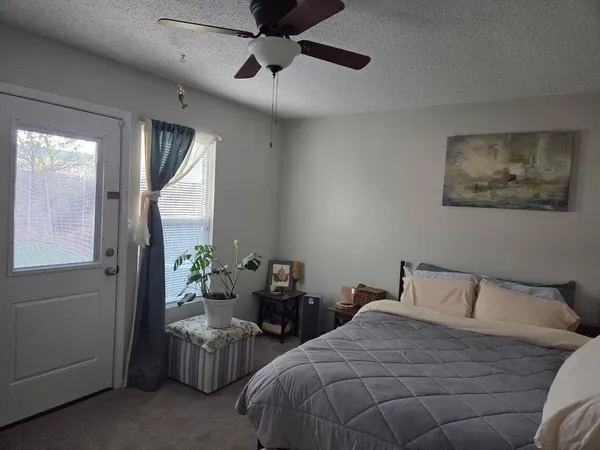 a bedroom with bed and window