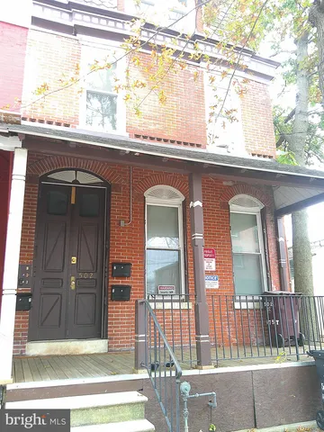 a view of a brick house with large windows