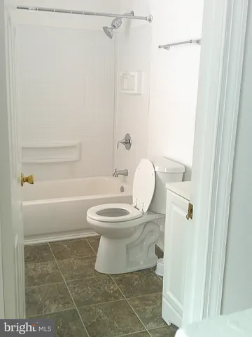 a white toilet sitting next to a bathroom sink