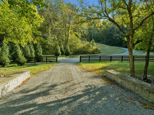 a view of a yard with wooden fence