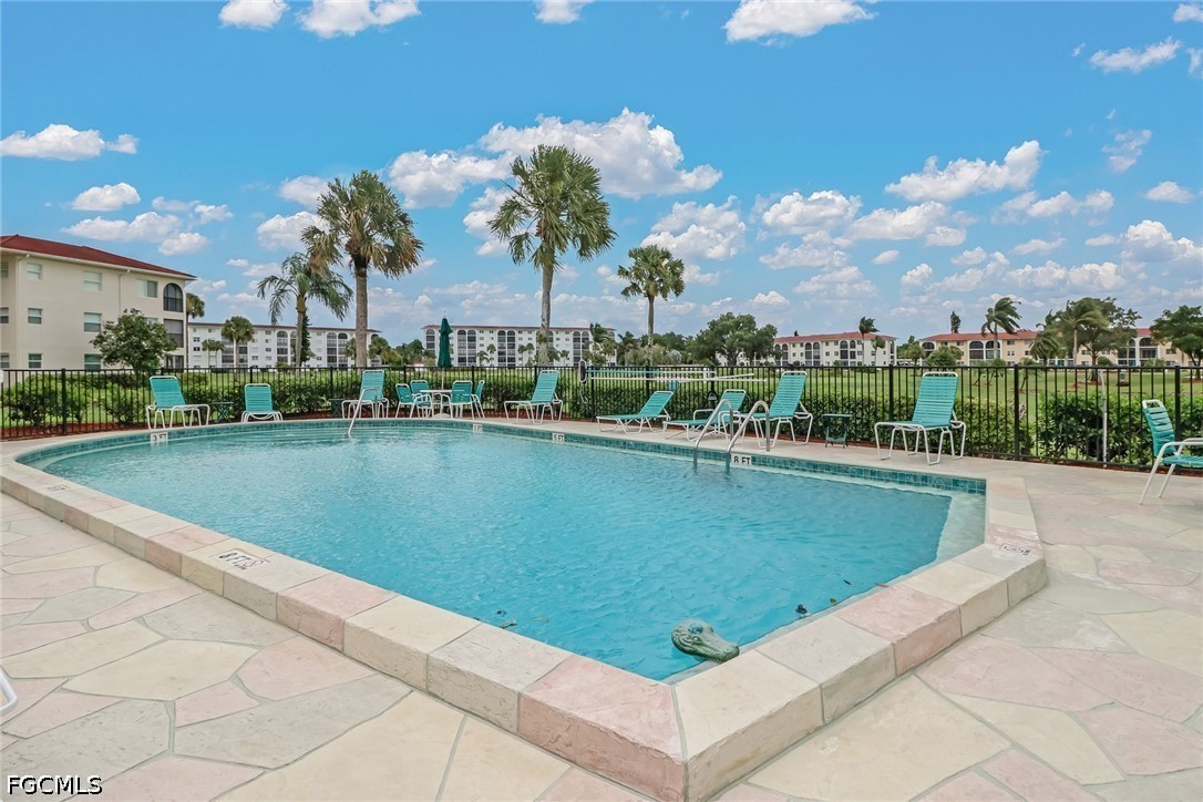 9 High Point Circle North, Unit 101 Naples, FL 34103 - Photo 48 of 49 a view of a swimming pool and outdoor space