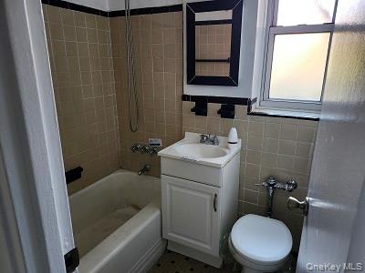 485 Bronx River Road, Unit B15 Yonkers, NY 10704 - Photo 6 of 8 a bathroom with a sink a toilet and shower