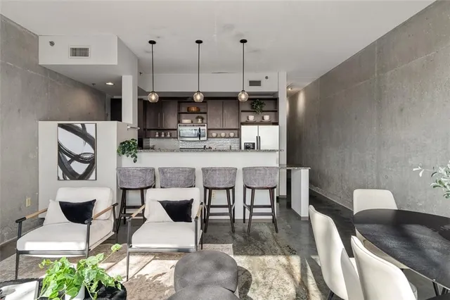 a kitchen with stainless steel appliances granite countertop a sink a stove and a wooden cabinets