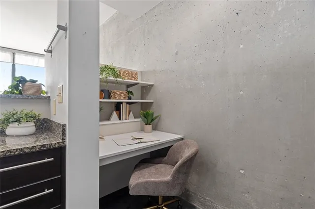 a walk in closet with view of bathroom