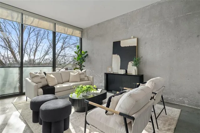 a living room with furniture and a potted plant
