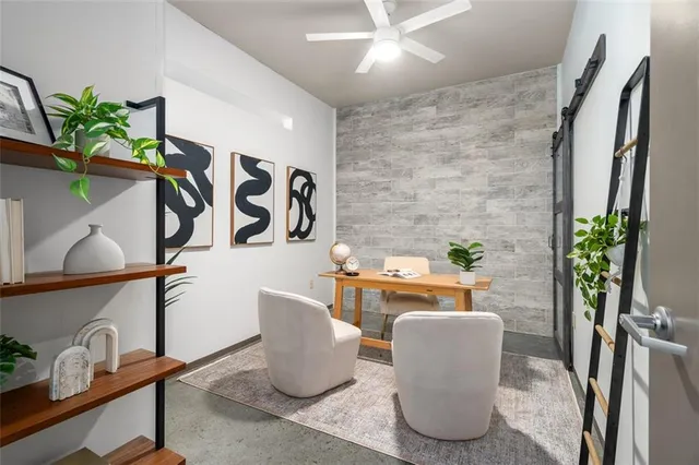 a living room with furniture and a potted plant