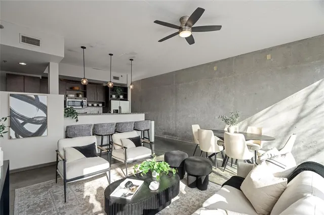 a living room with furniture and kitchen view
