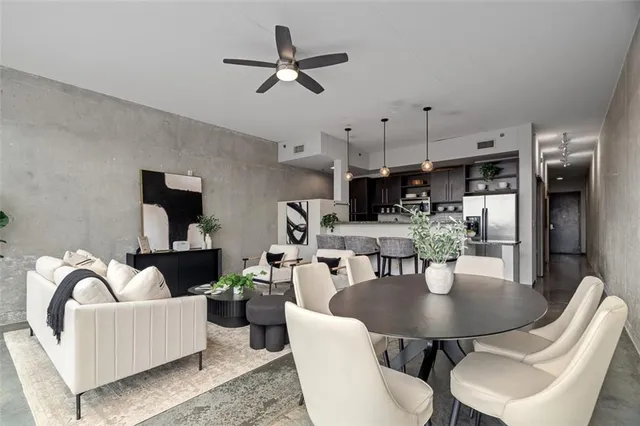 a living room with furniture and a kitchen