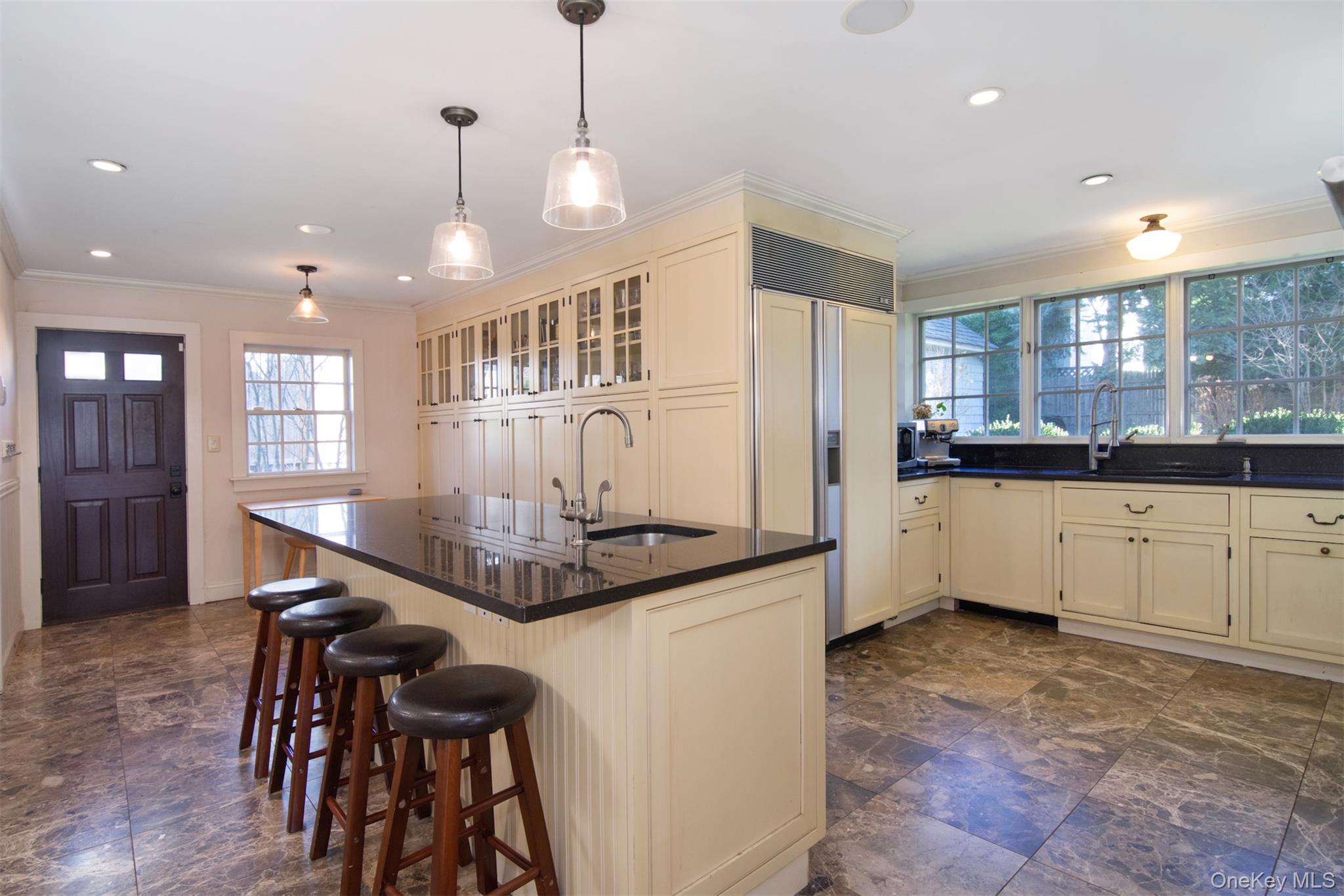 414 Pelham Manor Road Pelham, NY 10803 - Photo 6 of 32 a kitchen with stainless steel appliances kitchen island granite countertop a stove a sink a refrigerator and white cabinets with wooden floor