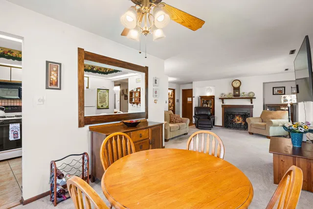 a living room with furniture a fireplace and a chandelier