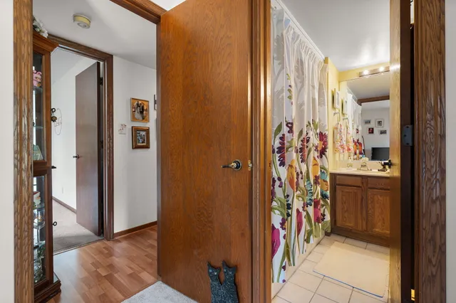 a view of a bathroom with mirror and door