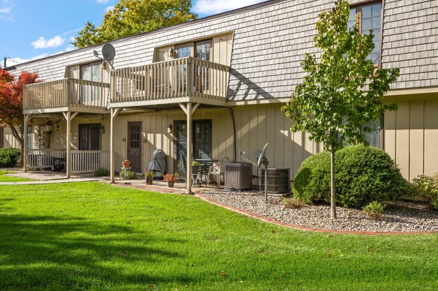 a view of a house with a yard and sitting area