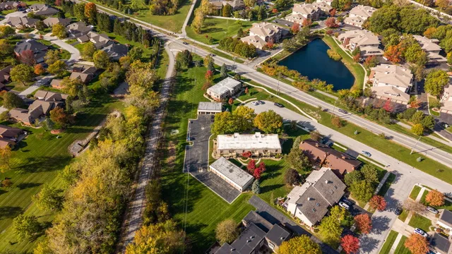an aerial view of a house with a yard and plants