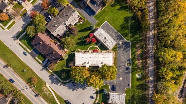 an aerial view of a house with a yard and outdoor seating