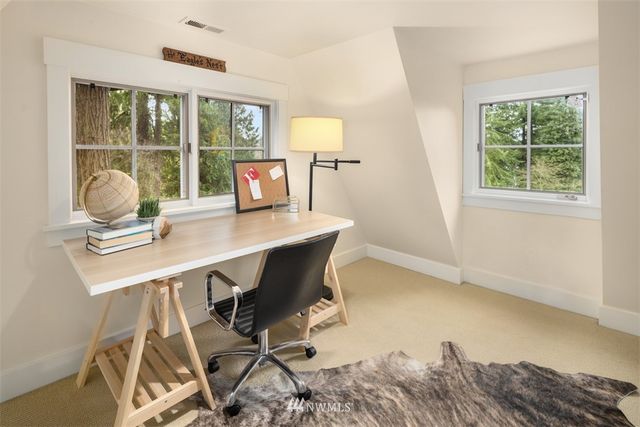 a workspace with furniture and window