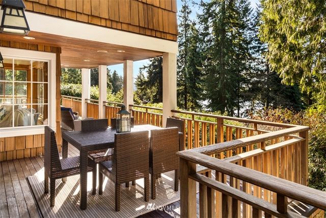 a view of a chairs and table in the balcony
