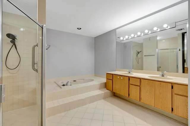 a bathroom with a tub sink and mirror
