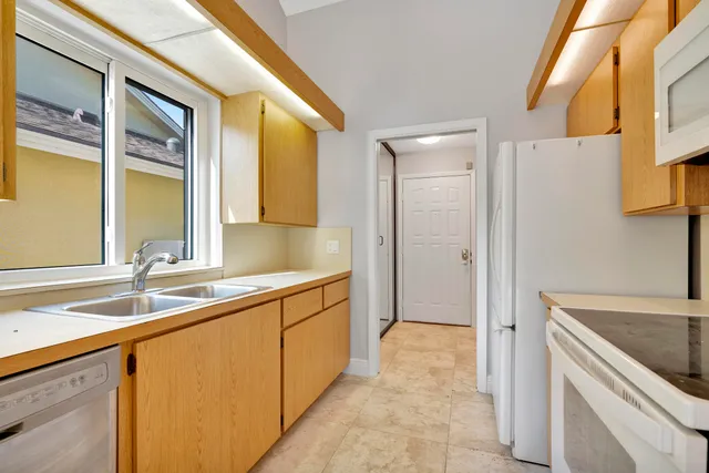 a kitchen with a sink and a refrigerator