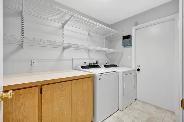 a bedroom with large window and a bed