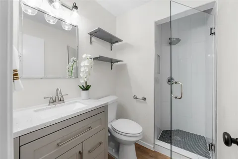 a bathroom with a sink toilet and shower