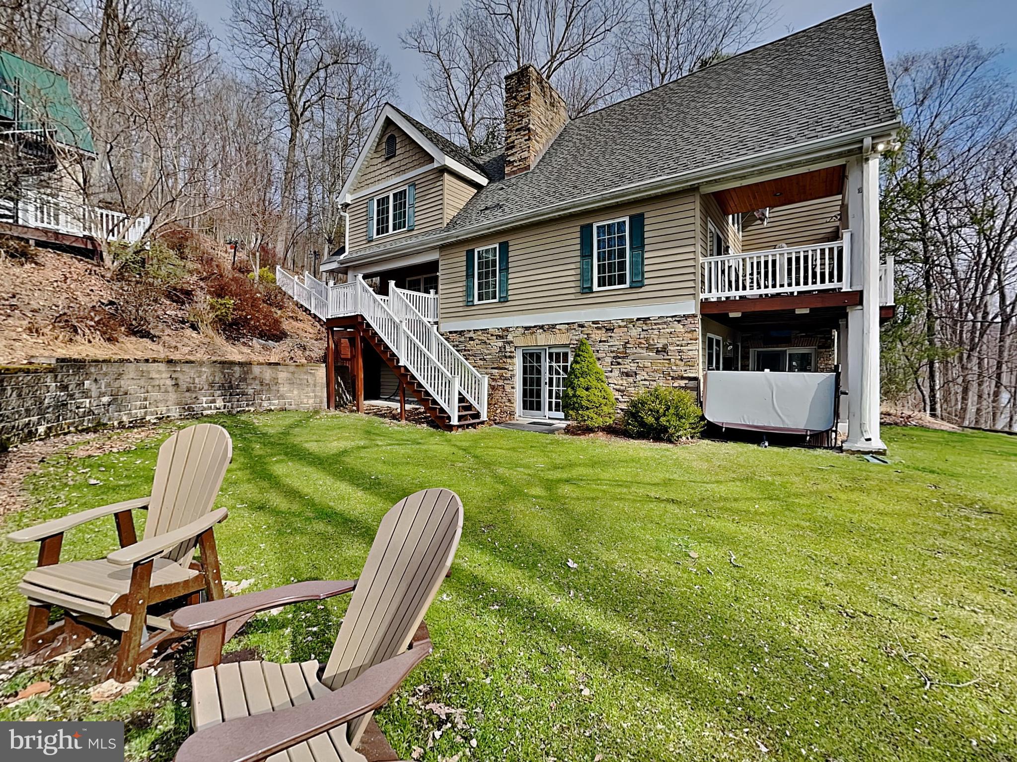 3067 Shingle Camp Road McHenry, MD 21541 - Photo 1 of 68 a house view with a seating space and garden