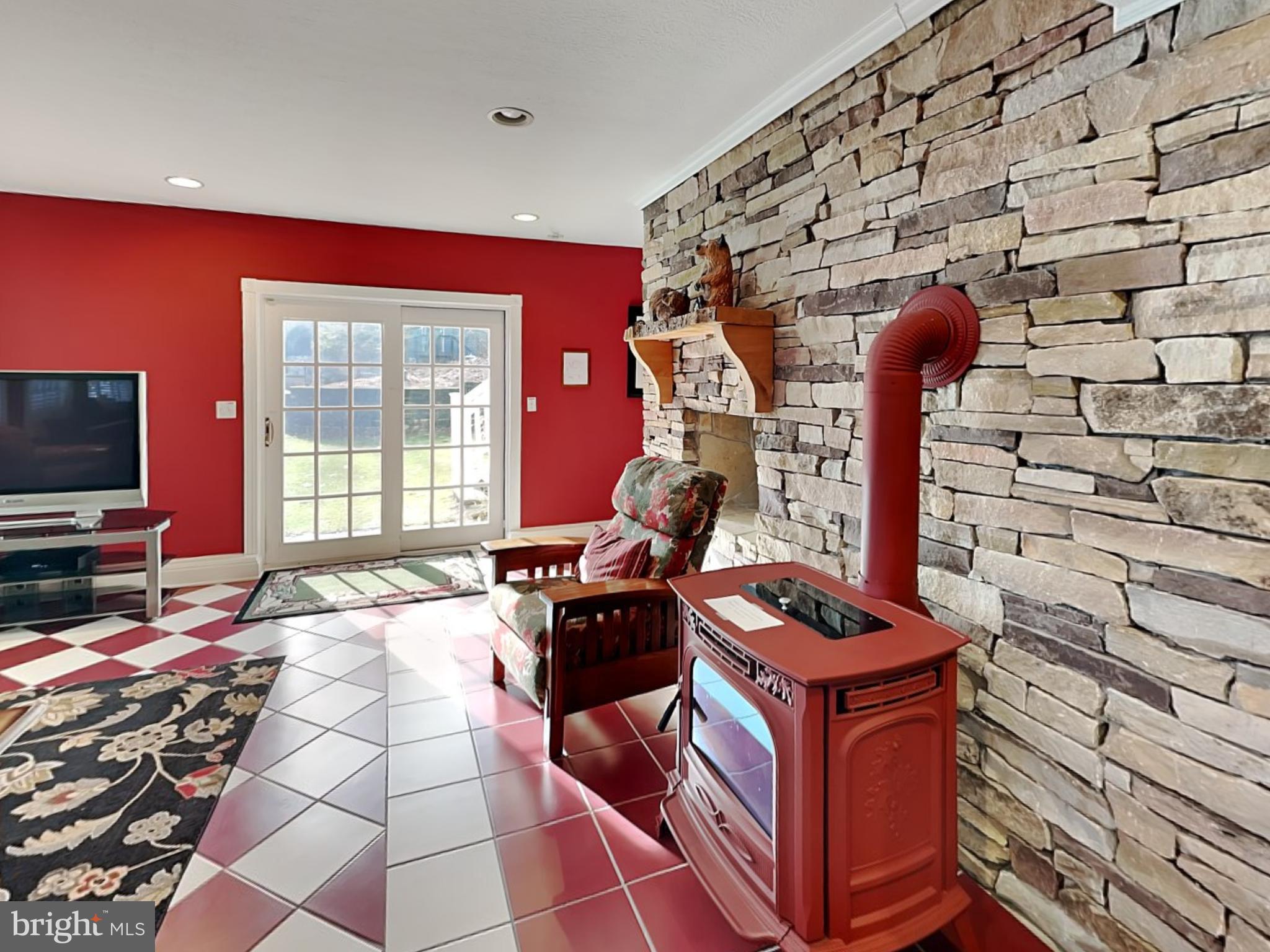 3067 Shingle Camp Road McHenry, MD 21541 - Photo 12 of 68 a room with furniture a flat screen tv and a fireplace