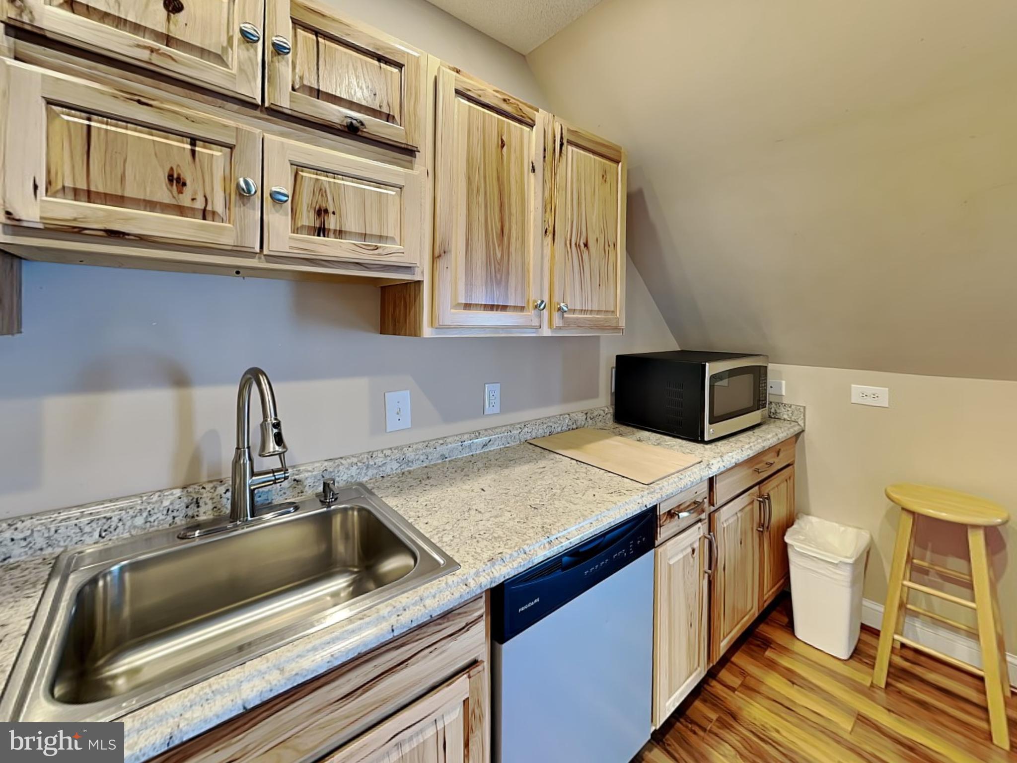 3067 Shingle Camp Road McHenry, MD 21541 - Photo 18 of 68 a kitchen with stainless steel appliances a sink a stove and a microwave oven