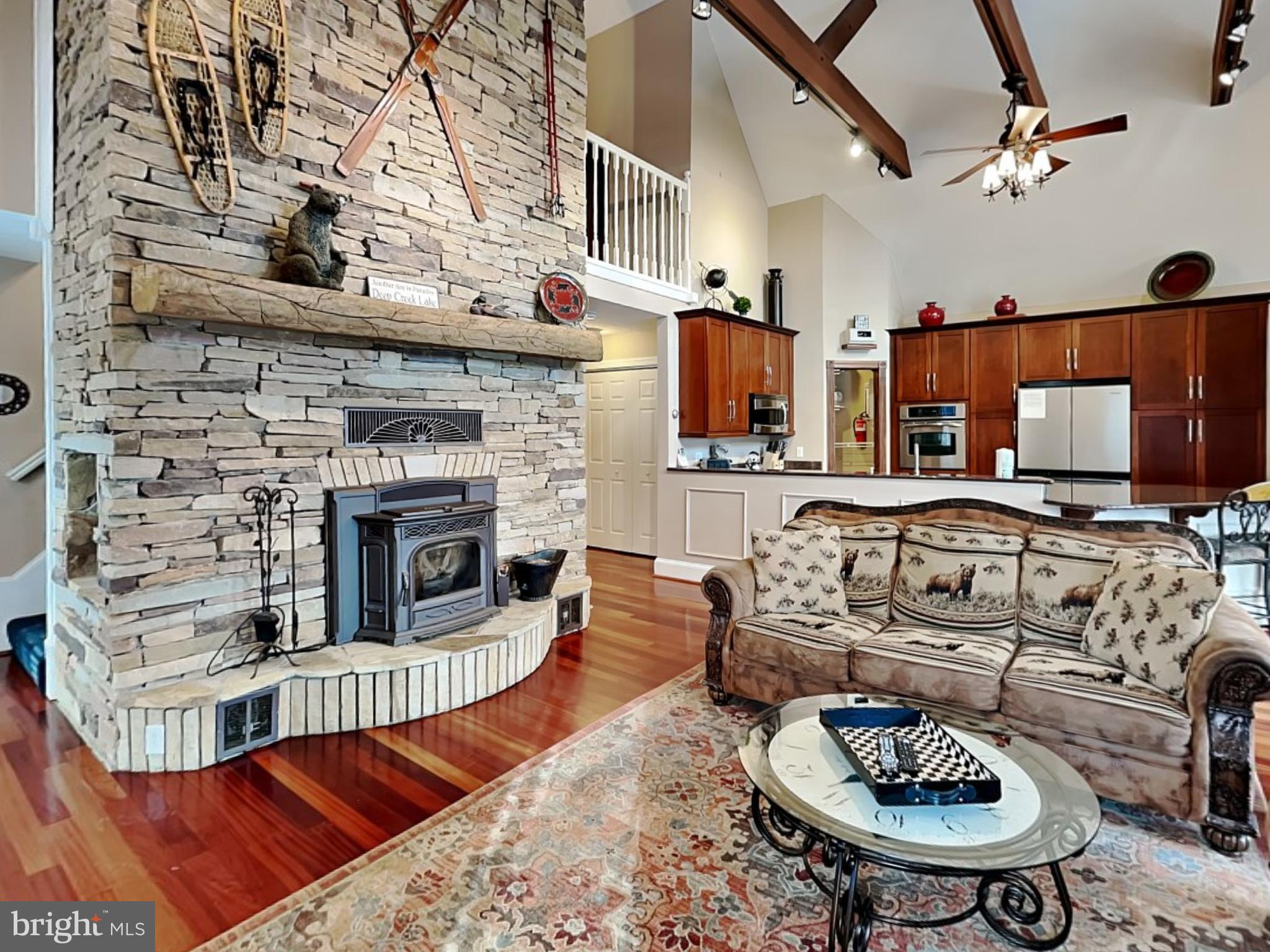 3067 Shingle Camp Road McHenry, MD 21541 - Photo 2 of 68 a living room with furniture a fireplace and a flat screen tv