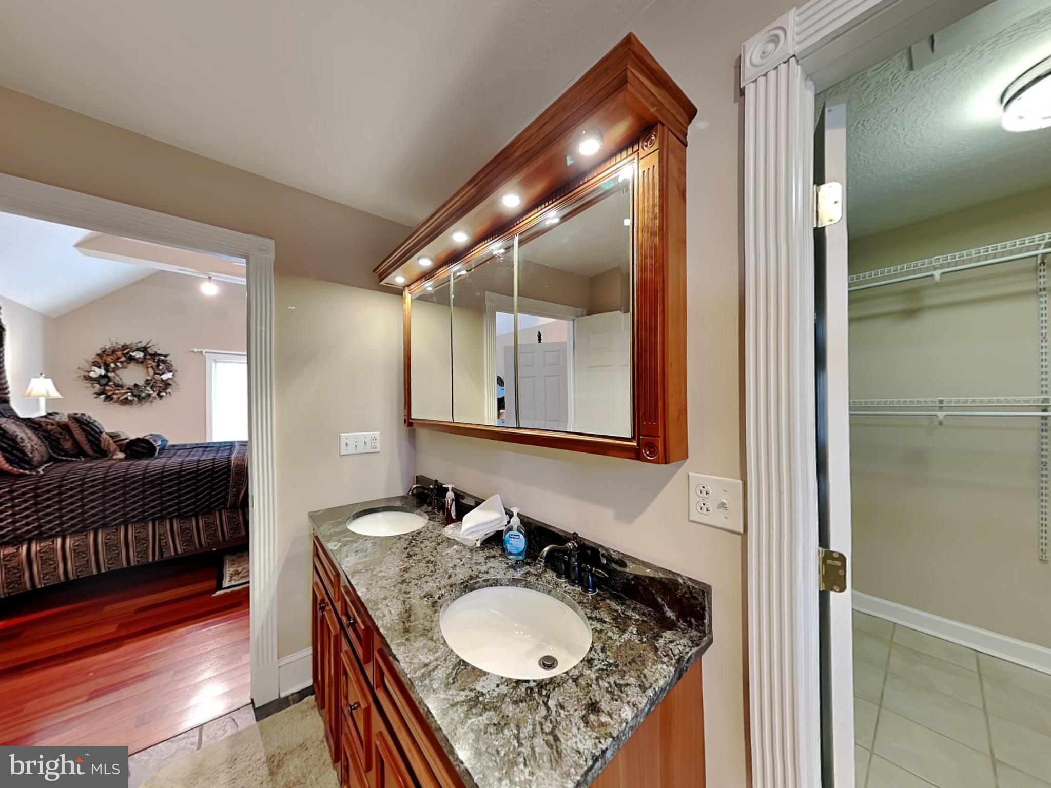 3067 Shingle Camp Road McHenry, MD 21541 - Photo 24 of 68 a en suite bathroom with a granite countertop sink and a mirror