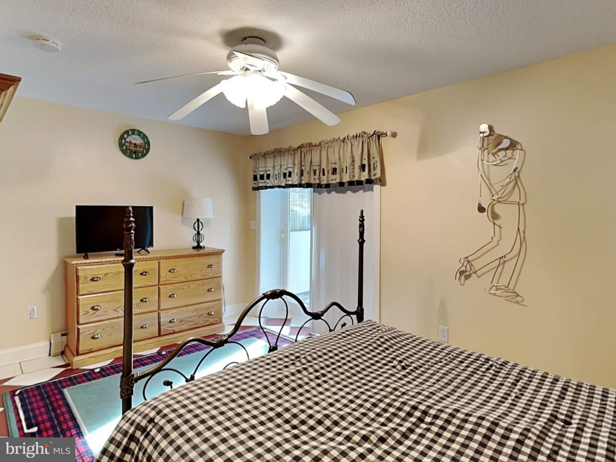 3067 Shingle Camp Road McHenry, MD 21541 - Photo 33 of 68 a bedroom with a bed and a flat screen tv