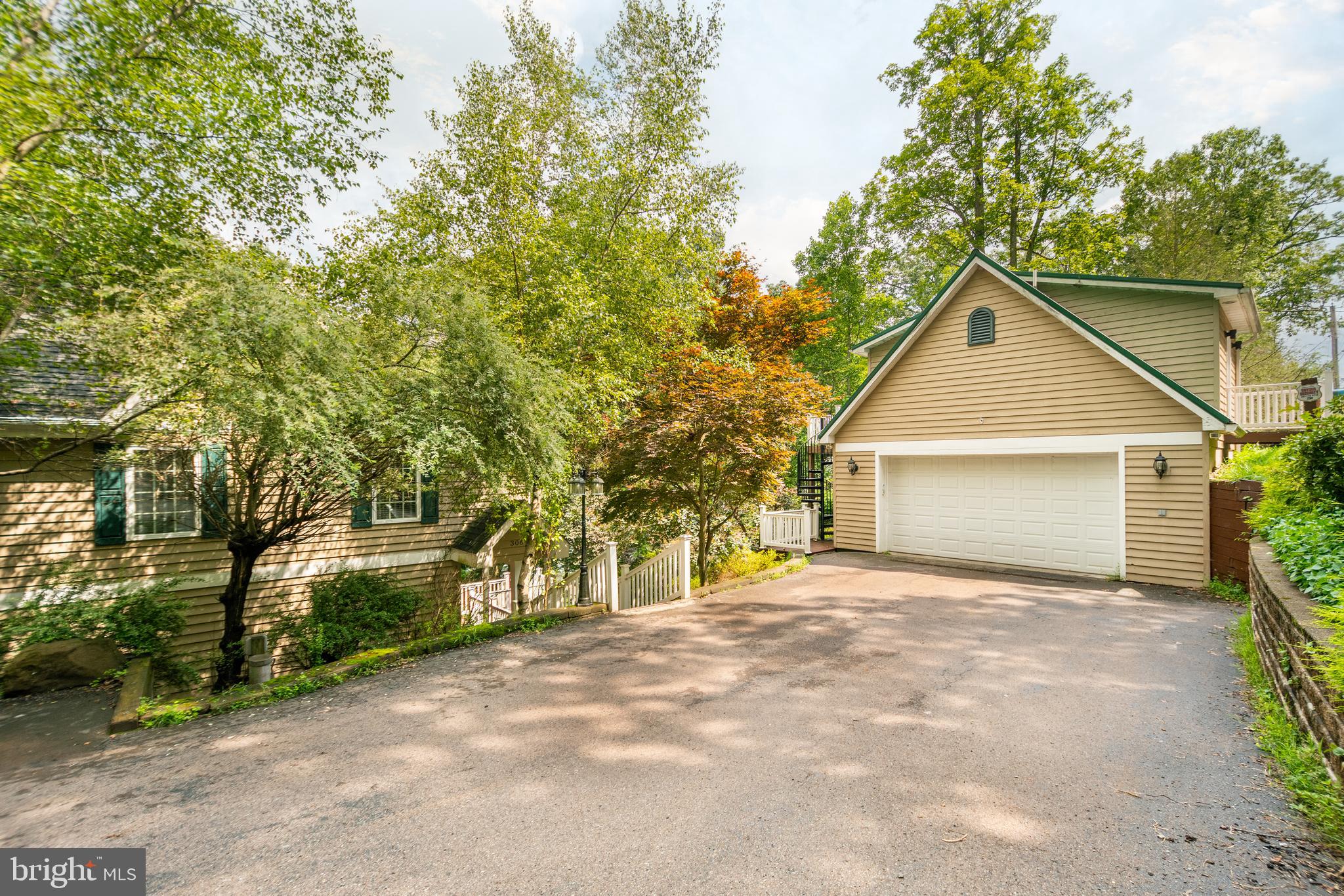 3067 Shingle Camp Road McHenry, MD 21541 - Photo 60 of 68 a front view of a house with a yard and garage