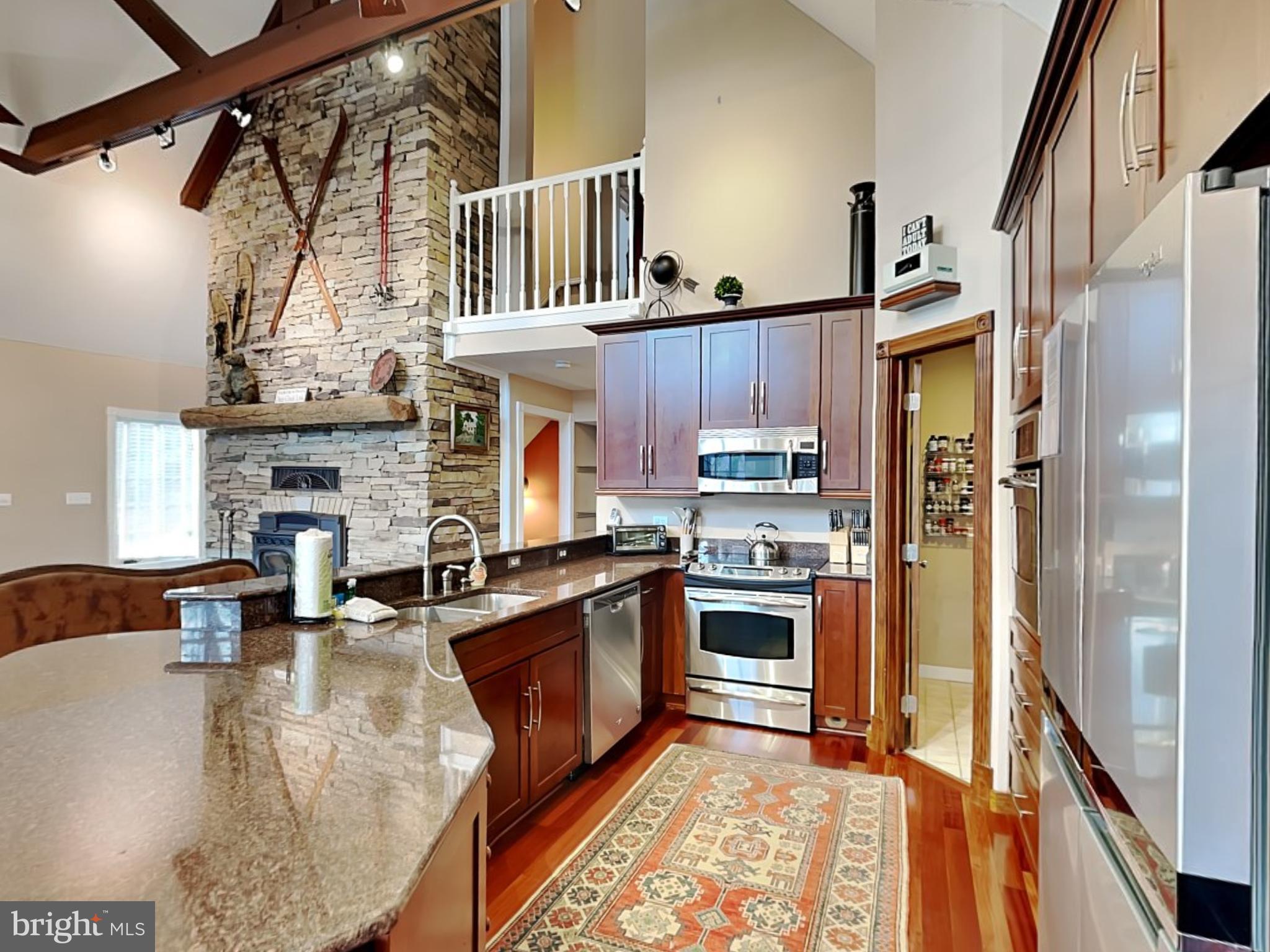 3067 Shingle Camp Road McHenry, MD 21541 - Photo 7 of 68 a kitchen with stainless steel appliances granite countertop a stove refrigerator and cabinets