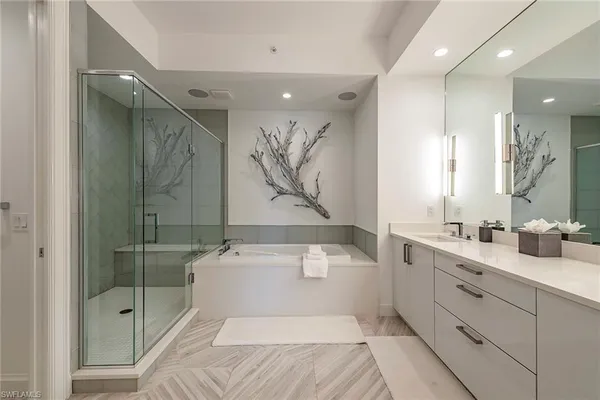 a en suite bathroom with a shower sink and mirror