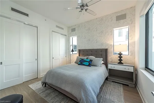 a bedroom with a bed and a chandelier